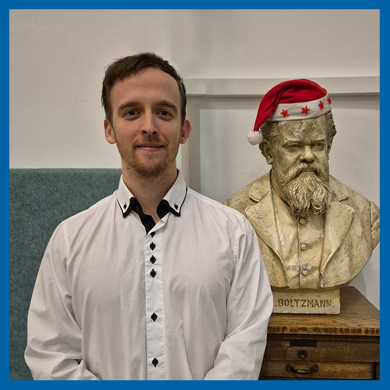 Milán Rozmán (next to Ludwig Boltzmann's bust) after being honored for his excellent academic performance by inclusion in the 2023/24 Dean's List.